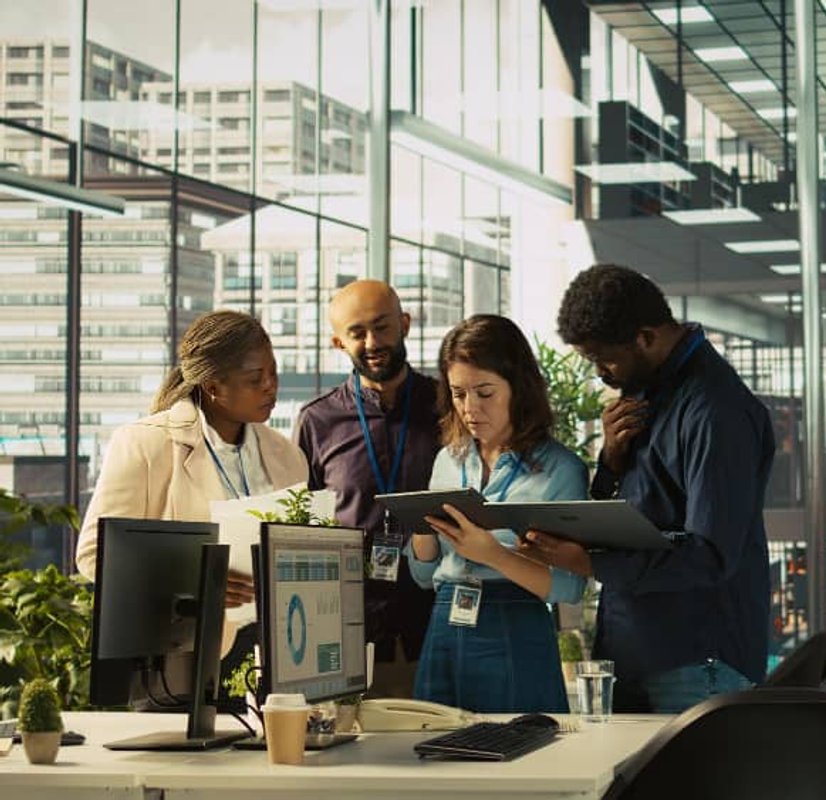 Diverse professionals collaborating on workforce planning with digital tools
