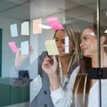 Two professionals mapping employer brand ideas on a glass wall